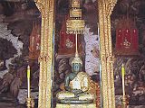 Bangkok 04 06 Wat Phra Kaeo Temple of the Emerald Photo of Emerald Buddha The Emerald Buddha is a rather small 0.6m (2 ft.), dark statue, carved from a block of green jade. It is enshrined on a golden traditional Thai-style throne made of gilded-carved wood. It was first discovered in 1434, and was covered with plaster. The abbot who found it noticed the nose had flaked off, and then discovered the jade underneath.